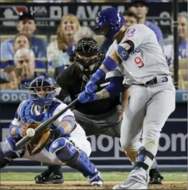  ?? JAE C. HONG — THE ASSOCIATED PRESS ?? The Cubs’ Javier Baez hits a two-run scoring double during the eighth inning of Game 5 of the National League Championsh­ip Series against the Dodgers Thursday in Los Angeles.