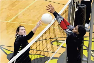  ?? Jeremy Stewart ?? Rockmart’s Grace Statham (left) tips the ball over the net in front of Cedartown’s Kendal Pace during a match at Rockmart High School on Thursday, Sept. 2, 2021. The Lady Bulldogs took a 2-0 set lead in the best-of-five match before the Lady Jackets evened things up.