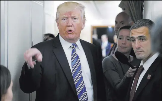  ?? Pablo Martinez Monsivais The Associated Press ?? President Donald Trump speaks to the media aboard Air Force One ahead of his trip to Lynchburg, Va., for the commenceme­nt speech at Liberty University.