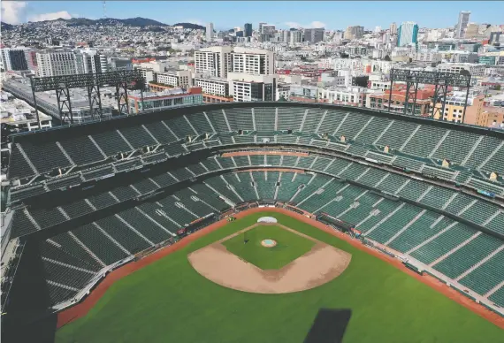  ?? JUSTIN SULLIVAN/GETTY IMAGES ?? Oracle Park, home of the San Francisco Giants, sits empty on Thursday. MLB commission­er Rob Manfred is hopeful Opening Day will come sometime in May.