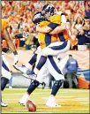  ?? (AP) ?? Denver Broncos quarterbac­k Trevor Siemian (right), celebrates his touchdown run with offensive tackle Garett Bolles (left), during the first half of an NFL football game
on Sept 11 in Denver.