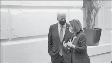  ?? SCOTT APPLEWHITE/AP ?? President Joe Biden and Speaker of the House Nancy Pelosi, D-calif., talk in a basement hallway of the Capitol after meeting with House Democrats to rescue his his $3.5 trillion government overhaul and salvage a related public works bill, in Washington, Friday, Oct. 1, 2021.