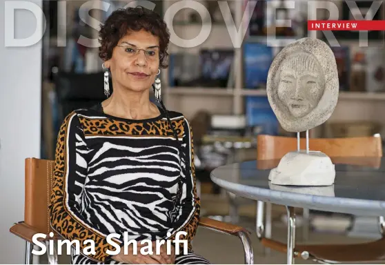  ??  ?? Sima Sharifi at her Vancouver home next to a carving by Billy Merkosak, an artist based in Pond Inlet, Nunavut.
