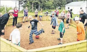  ?? GUARDIAN FILE PHOTO ?? Will Harrison, left, (wearing ball cap), works with younger children as they pay gaga ball at Camp Red Fox for children with diabetes in Canoe Cove in this Guardian file photo. Harrison attended the diabetes camp for five years and later worked as a...