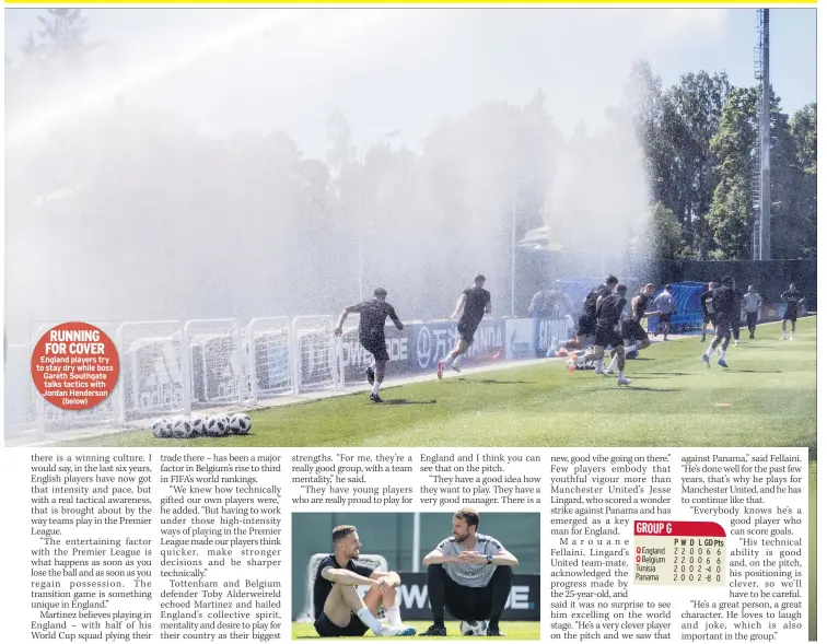  ??  ?? RUNNING FOR COVER England players try to stay dry while boss Gareth Southgate talks tactics with Jordan Henderson (below)