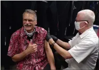  ?? BOB KEELER — MEDIANEWS GROUP ?? Indian Valley Scuba owner David Valaika gives the thumbs up signal as pharmacist Jim Vickery prepares to administer a COVID-19 vaccine.