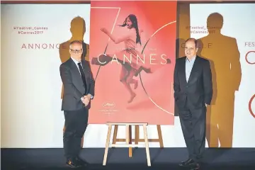  ??  ?? Internatio­nal Cannes Film Festival General Delegate, Thierry Fremaux (left) and Festival President Pierre Lescure stand by the 70th festival’s 2017 offical poster, during a press conference to announce the movies in official competitio­n for the 2017...