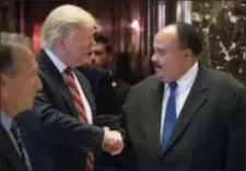  ?? ANDREW HARNIK — THE ASSOCIATED PRESS FILE ?? FILE- In this file photo, President-elect Donald Trump shakes hands with Martin Luther King III, son of Martin Luther King Jr. at Trump Tower in New York. King III, met with Trump on the last King holiday, four days before Trump took office.