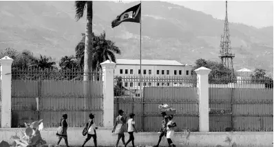  ?? ?? People walk past the National Palace in Port-au-Prince, Haiti, on Monday, March 25, 2024.