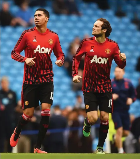  ?? Getty Images ?? With holes due to suspension­s or injuries at the moment, Jose Mourinho will probably turn to Chris Smalling, left, Daley Blind, right, and Victor Lindelof as his back three next week. Youth academy product Demetri Mitchell, 20, may also figure at some...