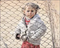  ??  ?? Child left behind: A young refugee west of Mosul, Iraq, on Monday.