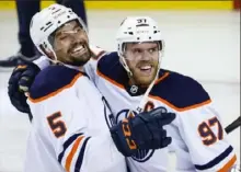  ?? Jeff McIntosh/Canadian Press ?? Edmonton’s Connor McDavid, right, celebrates his winning goal Thursday night with Cody Ceci. These Oilers have fans thinking about a Stanley Cup last won more than 30 years ago.