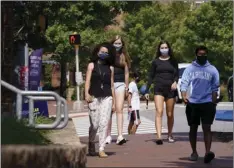  ?? AP
PHOTO/GERRY BROOME, ?? In this Aug. 18 file photo, students wear masks on campus at the University of North Carolina in Chapel Hill, N.C. As more and more schools and businesses around the country get the OK to reopen, some college towns are moving in the opposite direction because of too much partying and too many COVID-19 infections among students.