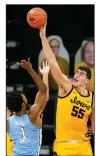  ?? (AP/Charlie Neibergall) ?? Iowa center Luka Garza ( 55) blocks a shot by North Carolina guard Leaky Black (1) during the second half of the No. 3 Hawkeyes’ 93-80 victory over the No. 16 Tar Heels on Tuesday in Iowa City, Iowa.