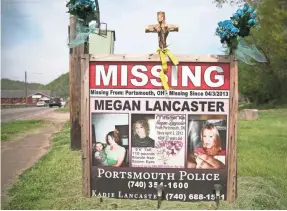  ?? LIZ DUFOUR/USA TODAY NETWORK ?? A sign in New Boston reminds the community of the missing woman.