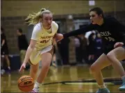  ?? ?? Mead’s Madi Clark dribbles with Silver Creek’s Izzy Spagnolett­i pressuring her Friday at Mead High.