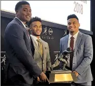  ?? AP/RALPH RUSSO ?? Heisman Trophy finalists (from left) Dwayne Haskins (Ohio State), Kyler Murray (Oklahoma) and Tua Tagovailoa (Alabama) pose with the Heisman Trophy at the New York Stock Exchange on Friday in New York. A quarterbac­k will win college football’s most coveted individual award for the 16th time in the past 19 years.