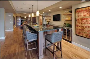  ?? Photos: Albi Homes ?? The bar in the rec room of the developed basement of the Carrara model by Albi Homes.