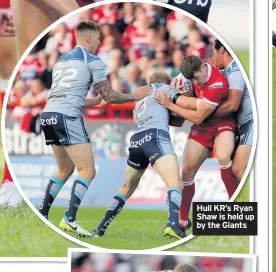  ??  ?? Hull KR’s Ryan Shaw is held up by the Giants