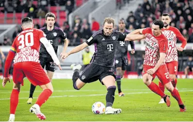  ?? AP ?? Bayern Munich’s Harry Kane (centre) prepares to take a shot during the Bundesliga match between SC Freiburg and Bayern Munich at the Europa-Park Stadium in Freiburg, Germany yesterday.