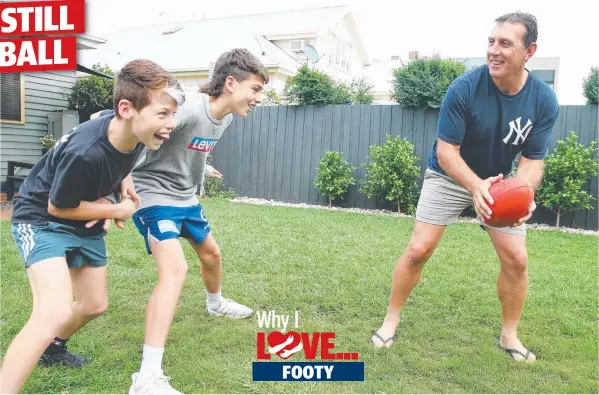  ?? Picture: ALAN BARBER ?? RICCO’S LEGACY: Peter Riccardi playing backyard footy with his sons Boston, 12, and Osca, 15, who both play for Newtown & Chilwell.