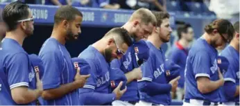  ?? BERNARD WEIL/TORONTO STAR ?? The Blue Jays line up for a minute’s silence to remember the victims of the 9/11 terrorist attacks in the United States before Sunday’s home game against the Boston Red Sox.