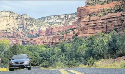  ?? Ricardo DeAratanha Los Angeles Times ?? CANYON WALLS and stunning sandstone cliffs frame the spectacula­r drive across the landscape of Sedona, Ariz.