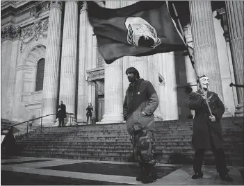  ?? — GETTY IMAGES ?? Occupy London SX protesters, who lost an appeal to demonstrat­e inside the London Stock Exchange Wednesday, move the venue to St Paul’s Cathedral.