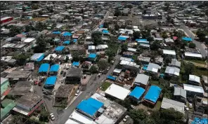  ?? AP/DENNIS M. RIVERA ?? There are signs of recovery in Puerto Rico after last year’s devastatin­g hurricanes, but many homes like these in Catano, east of San Juan, still have temporary roofs.