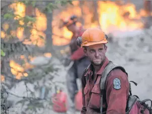  ?? CP PHOTO ?? A B.C. Wildfire Service firefighte­r looks on while conducting a controlled burn to help prevent the Finlay Creek wildfire from spreading near Peachland, B.C., on Thursday, Sept. 7.