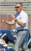  ?? STAFF PHOTO BY ROBIN RUDD ?? UTC football coach Rusty Wright encourages the Mocs as they warm up before facing VMI on Oct. 15 at Finley Stadium. The Mocs will play three of their final four regular-season games on the road, starting with Saturday’s visit to Furman.