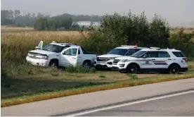  ?? Photograph: Lars Hagberg/AFP/Getty Images ?? Royal Canadian Mounted Police vehicles are seen next to a pickup truck where suspect Myles Sanderson was arrested, and later died from self-inflicted injuries.