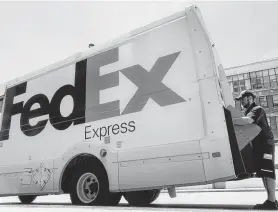  ?? John Minchillo / Associated Press ?? FedEx vowed to continue investing in improved service even as the profit outlook weakens. The company is moving to year-round, seven-days-a-week service in January, investing to handle oversize items.