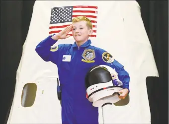  ?? Erik Trautmann / Hearst Connecticu­t Media ?? Apollo 12 Commander Timmy Hopkins emerges from the capsule during Columbus Magnet School’s annual Young Astronauts Mission Landing event Friday at the school in Norwalk. The landing ceremony for their 2019 mission mimicked the two Apollo moon landing missions, 11 and 12.