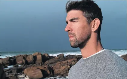  ??  ?? Michael Phelps, the most decorated Olympian with 23 gold medals, faces the toughest race of his swimming career when he races a great white shark over 100m in open water in
Phelps vs. Shark: Great Gold vs. Great
White.
PHOTO: SUPPLIED