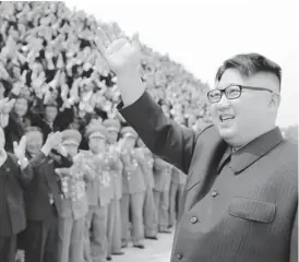  ??  ?? North Korean leader Kim Jong-un waves to officials in this undated photo —Reuters