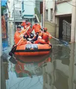  ?? Reuters, AFP ?? Far left: A man sits on a car partially submerged in a flooded residentia­l area in Hyderabad yesterday. Left: National Disaster Response Force personnel evacuate local residents on a boat along a flooded street in Hyderabad.