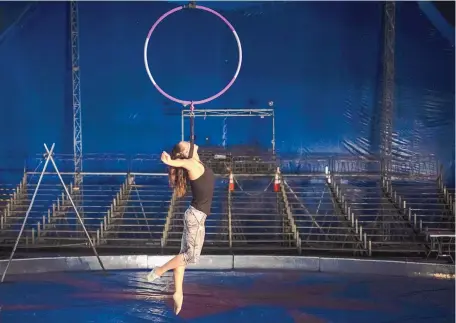  ?? ROBERTO E. ROSALES/JOURNAL ?? ABOVE: Susan Vance practices an aerial routine in the Do Portugal Circus big top on the grounds of the Eastern New Mexico State Fair.