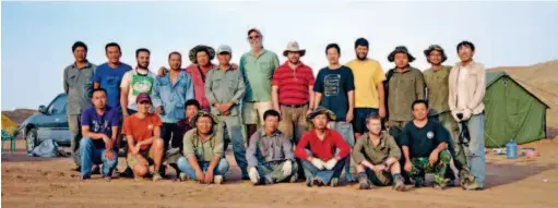  ??  ?? August 2011: Members of a China- U. S. joint survey team pose for a photo at their base camp in a desert in Xinjiang Uygur Autonomous Region. Professor James M. Clark ( 7th left, back row) from George Washington University has been a research partner of Xu Xing (5th right, back row) for many years. Since 2000, they have conducted scientific expedition­s in regions like Xinjiang and Inner Mongolia almost every year.