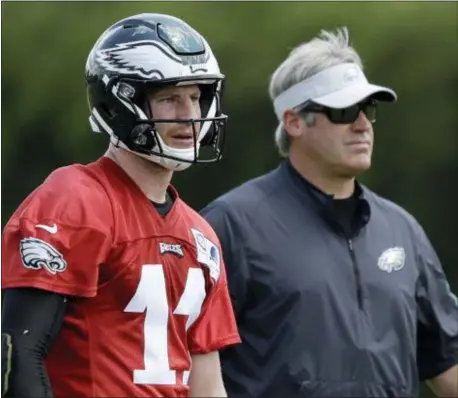  ?? MATT SLOCUM — THE ASSOCIATED PRESS ?? Assuming he receives medical clearance, quarterbac­k Carson Wentz, left, will likely share first-team reps with Super Bowl MVP Nick Foles in training camp, Eagles coach Doug Pederson said Thursday at the end of the team’s three-day minicamp.