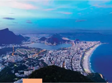  ??  ?? REAL IN RIO Above: the view over Rio from Dois Irmãos (Two Brothers). Opposite, clockwise from left: the lobby at Grand Mercure Riocentro; volleyball on Ipanema beach; La Suite’s Black Suite; the wall across the road from Bar Urca.