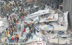  ?? Rebecca Blackwell, The Associated Press ?? Rescue workers on Wednesday search for people trapped inside a collapsed building in Mexico City.