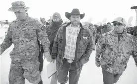  ?? AP ?? Ammon Bundy walks off after speaking with reporters during a news conference at Malheur National Wildlife Refuge headquarte­rs Monday near Burns, Oregon.