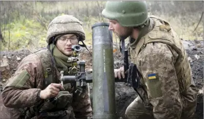  ?? AP photo ?? their mortar in the front line position near Bakhmut, the site of the heaviest battle against the Russian troops in the Donetsk region, Ukraine on Thursday.