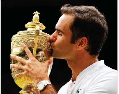  ?? CLIVE BRUNSKILL / GETTY IMAGES ?? In addition to earning his eighth trophy for a Wimbledon record, at 35 Roger Federer is the oldest men’s champion of the Open era (since 1968). Federer defeated Marin Cilic 6-3, 6-1, 6-4 in the championsh­ip match.