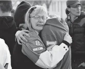  ?? JASON FRANSON/CANADIAN PRESS ?? Holly Borden, the mother of one of four high school football players killed in a crash in Grande Prairie, Alta., in October 2011, is consoled outside the courthouse where the driver who caused the crash was sentenced Wednesday. Brenden Holubowich was...