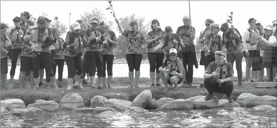  ?? Herald photo by Tim Kalinowski ?? The Rose Ceremony to remember cancer victims who have died is staged at Henderson Lake Saturday as part of the ATB Financial Lethbride Rotary Dragonboat festival. Despite rainy weather this year, it was still a poignant and beautiful moment.