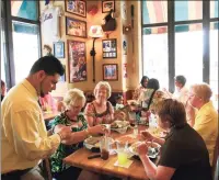  ?? Associated Press file photo ?? Customers order a meal at an Applebee’s Neighborho­od Grill & Bar in New York.