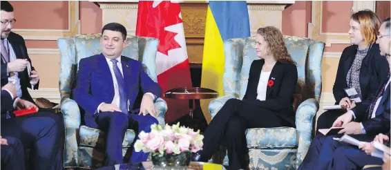  ?? SEAN KILPATRICK, THE CANADIAN PRESS | SERHII NUZHNENKO, THE ASSOCIATED PRESS ?? Translator Stanislav Yezhov, who was a senior aide and personal interprete­r to Ukrainian Prime Minister Volodymyr Groysman, is shown at far left in above photo and in a closeup at left. Yezhov was attending a meeting in Ottawa’s Rideau Hall on Nov. 1...