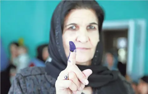  ?? RAHMAT GUL/AP ?? An Afghan woman shows her inked finger after casting her vote in Kabul on Oct. 20, 2018.